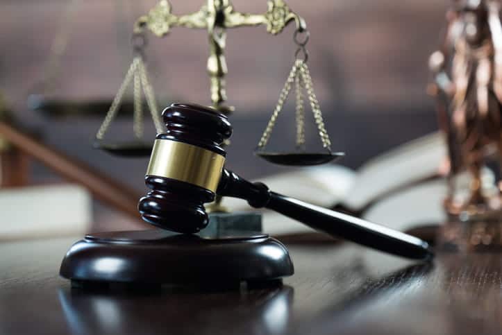 A gavel in front of the scales of justice on a dog bite attorney's desk. 