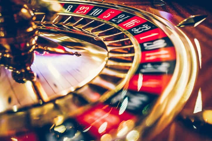 A closeup of a spinning casino roulette wheel.