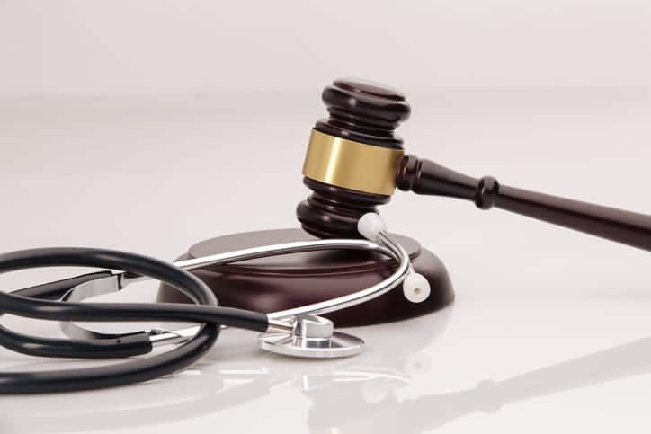 A stethoscope next to a gavel. 