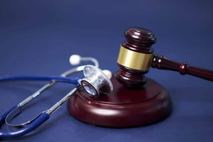 A stethoscope on top of a gavel.