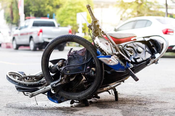 A severely damaged motorcycle after an accident. 