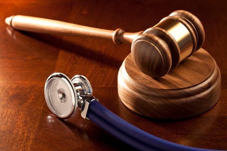 A gavel next to a stethoscope. 