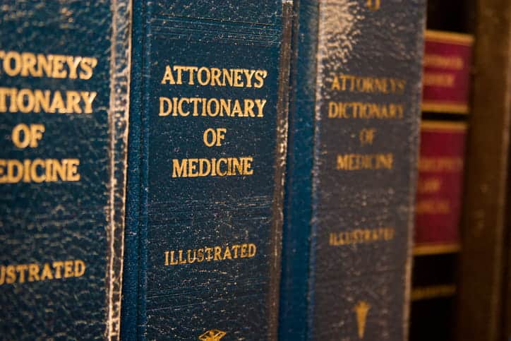 A row of books that read: "Attorneys' Dictionary Of Medicine."