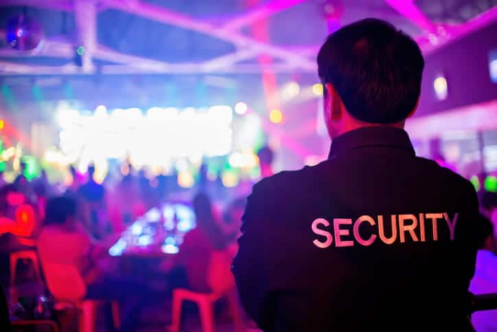 The back of a security guard watching the crowd at a downtown Las Vegas event.