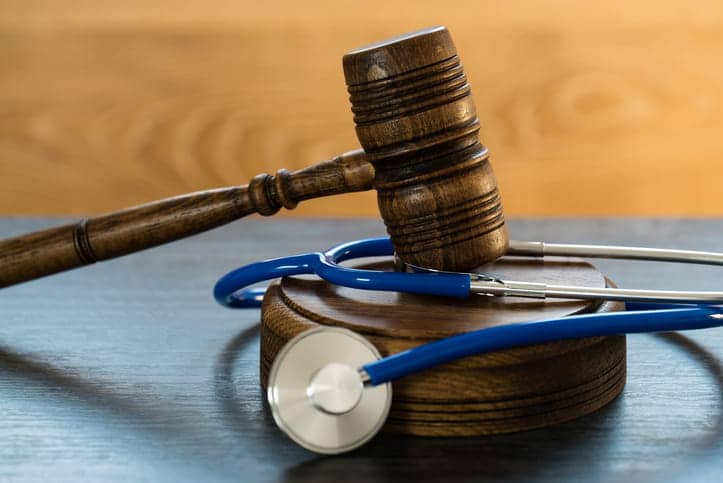 Seeking Compensation For Misdiagnosis 1 A wooden gavel with a stethoscope.