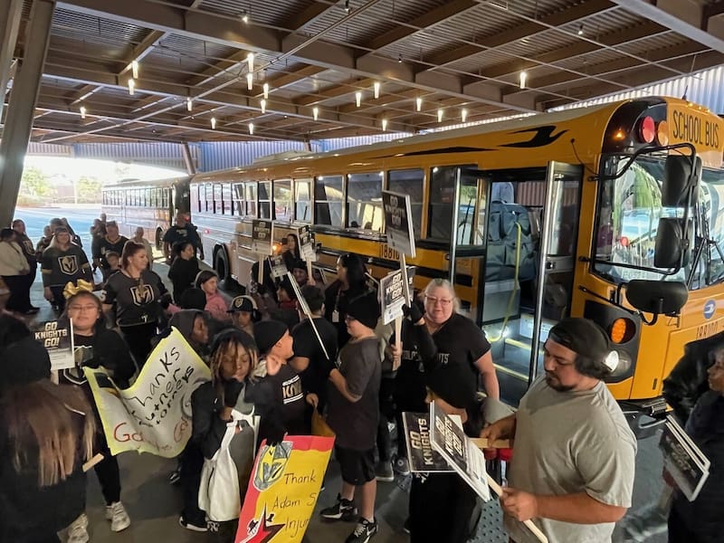 Past adam s. Kutner injury attorneys student winners about to board a bus.
