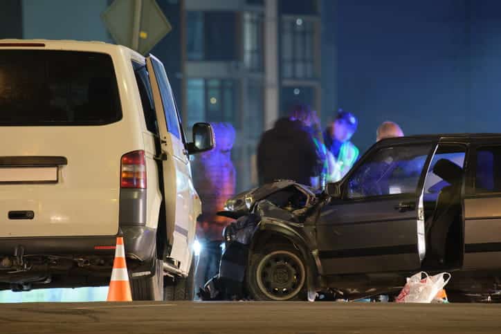 A car accident with a badly damaged front end to one of the vehicles.