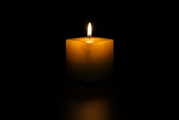 A candle lit in memorial after a wrongful death.