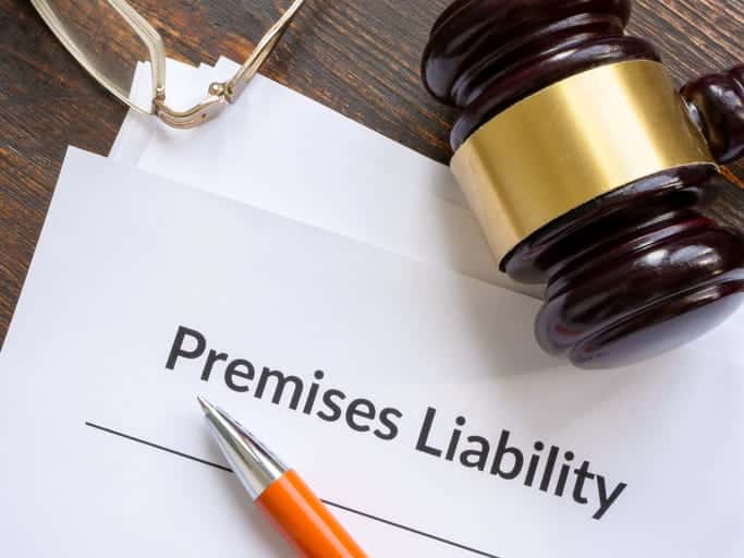 A paper that reads "premises liability" with a gavel over it.