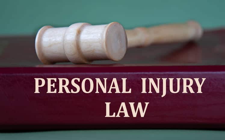 Silverado 12 A wooden gavel on top of book that reads "personal injury law. "