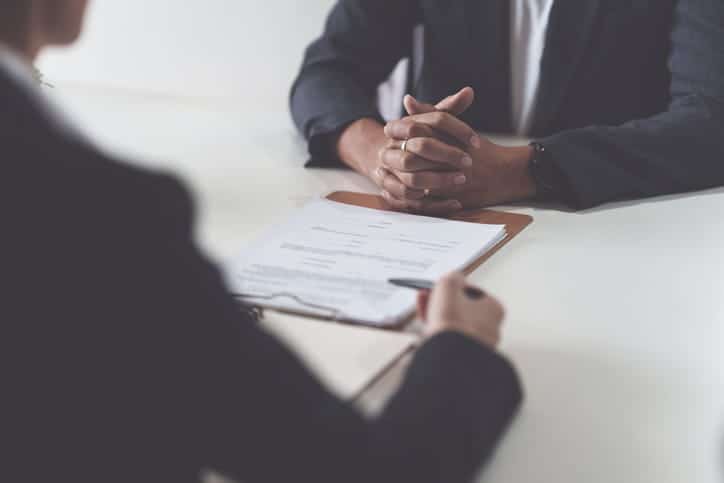 Mccullough Hills 12 A personal injury attorney discussing paperwork with a client.