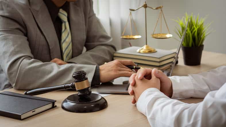 Amber Hills 12 An accident lawyer speaking to his client about a case.