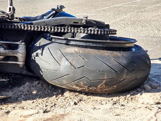 A tipped over motorcycle after an accident.