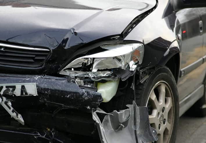 A severely damaged front end of a vehicle after a car accident.