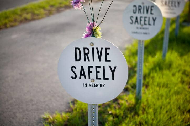 A sign that reads "drive safely in memory. "