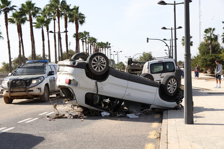 A vehicle on its roof after a roll over accident.