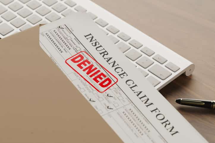 An insurance claim form that has a red stamp that reads: "denied. "