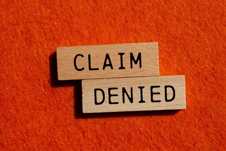Wooden blocks that read "claim denied. "