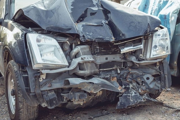 A severly damaged vehicle after a head-on collision.