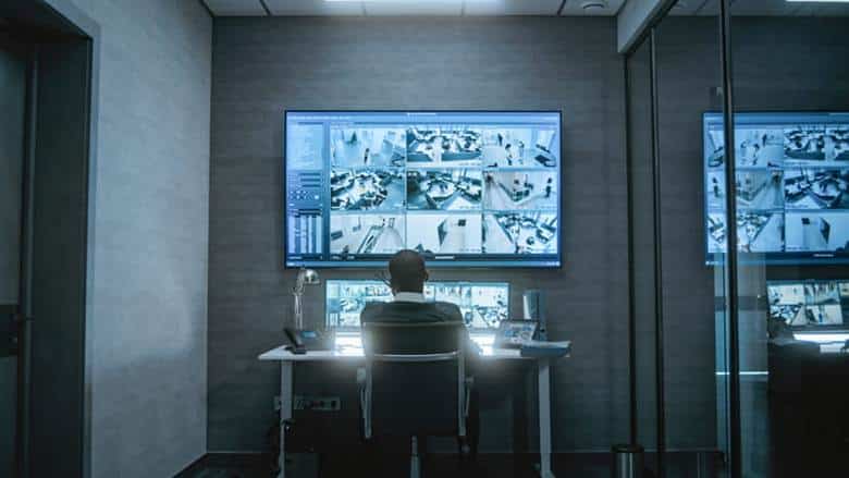 A man watching the security footage at a casino.