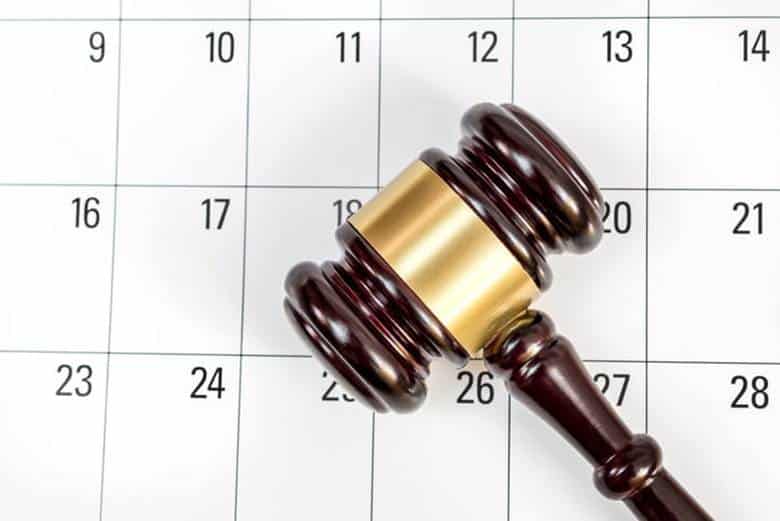 A gavel on top of a calendar.