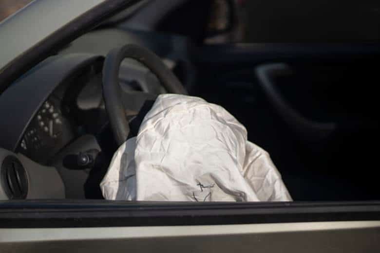 A deployed airbag in a vehicle after an accident.