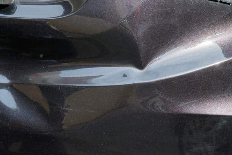 A dented vehicle after a low-impact car accident.