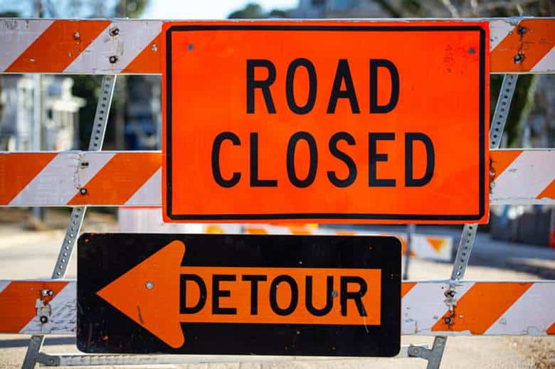 Construction signage that reads: "road closed" and "detour. "