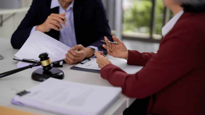 A lawyer discusses a case wit hher client.