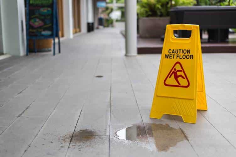 Average Slip-And-Fall Compensation In Las Vegas, Nv 10 A yellow wet floor sign next to a puddle.